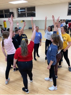 West Liberty University’s Dance Team gathers for a team huddle at the end of their practice.