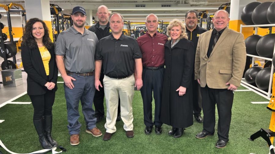 From left, WLU Foundation Executive Director Angie Zambito-Hill, Josh Contraguerro, Offensive Coach Dan Hopkins, Bob Contraguerro Jr., Bob and Jody Contraguerro Sr., Head Football Coach Roger Waialae and Athletic Director Lynn Ullom celebrate at the ribbon cutting for the Panhandle Performance Zone.