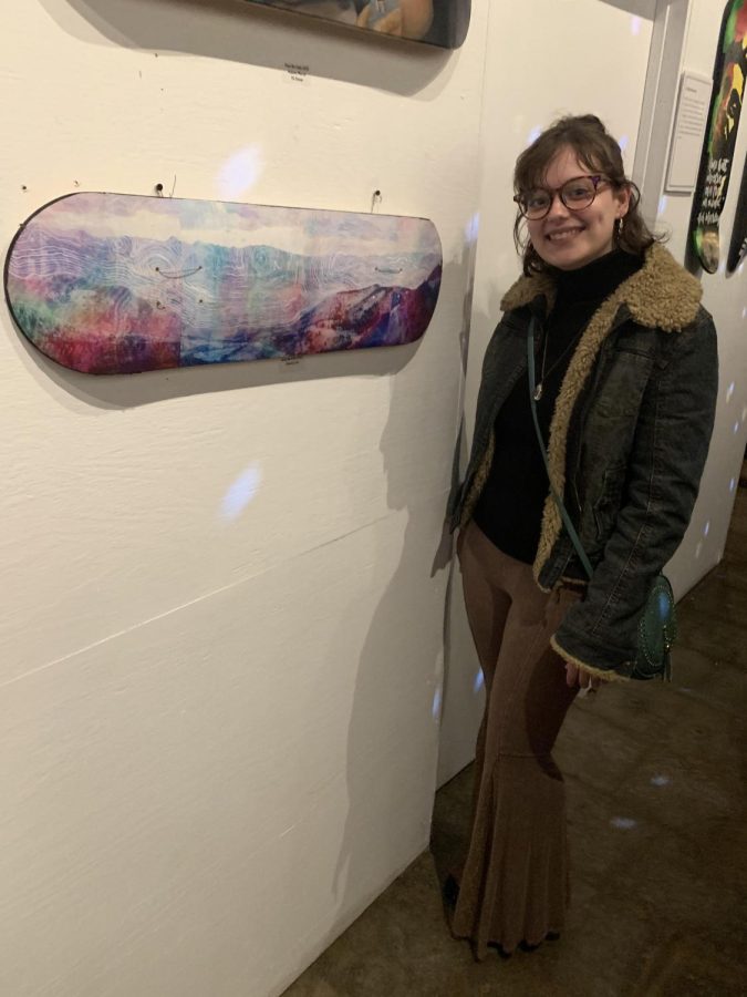 Lish alongside her work displayed in the Deck the Halls show at Clientele