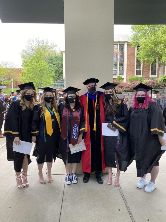 Criniti standing with WLU graduates.