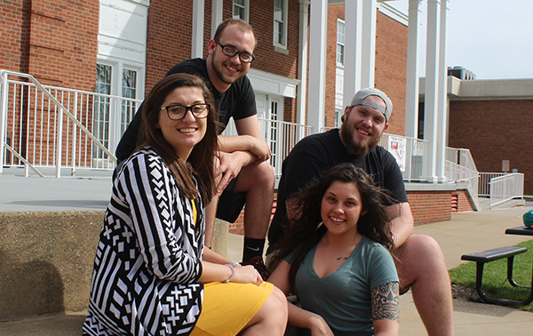 A group of Criminal Justice students sit outside of the College Union.