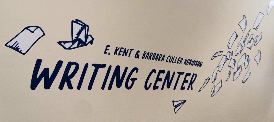 A photo of the sign for the E. Kent and Barbara Culler Robinson Writing Center that is on the wall on the first floor of the Elbin Library