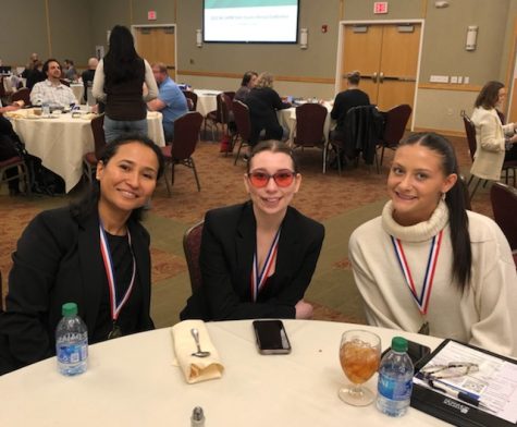 Tessa Ullom and Macie Roy accompanied by Professor Maskey during the conference portion of the competition.