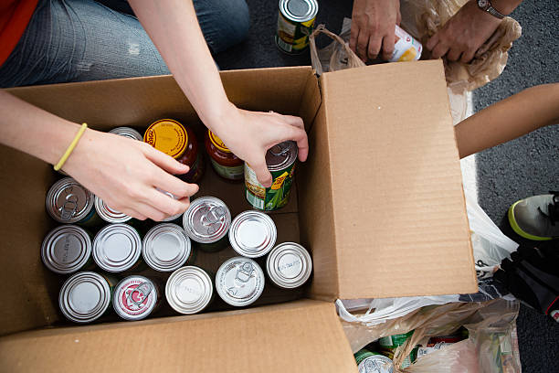 Fort Myers, FL, USA – March 24, 2013: Several volunteers packing name brand canned, non-perishable food in boxes during a food drive at Next Level Church in Fort Myers, FL.