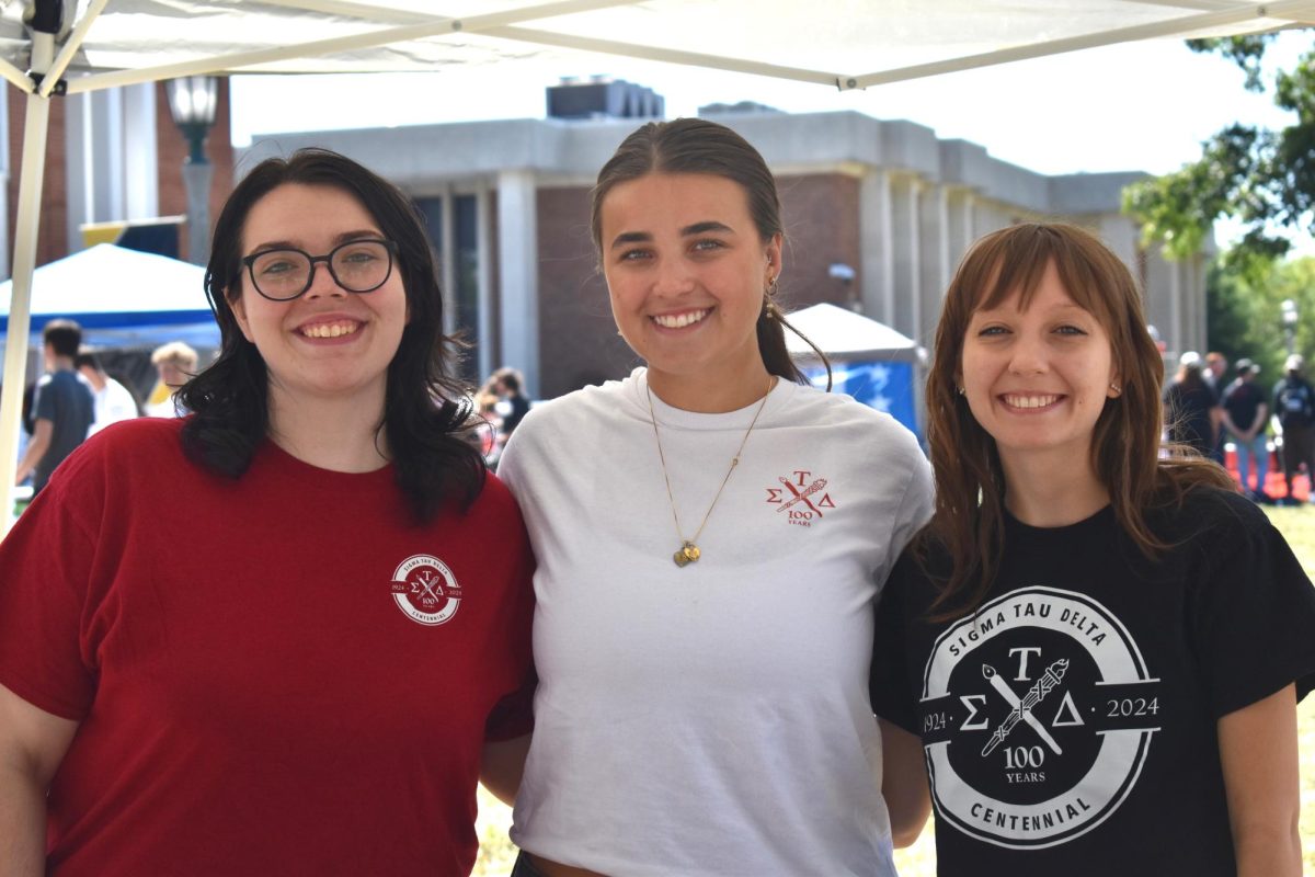 Scales Smith, Jenna Maguire, and Chloe Fidler pose at their table.