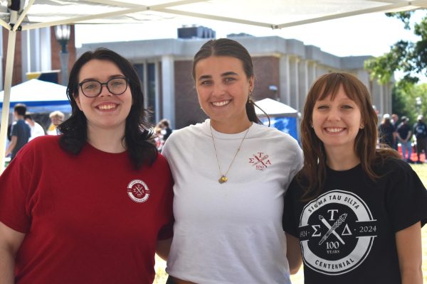 Scales Smith, Jenna Maguire, and Chloe Fidler pose at their table.