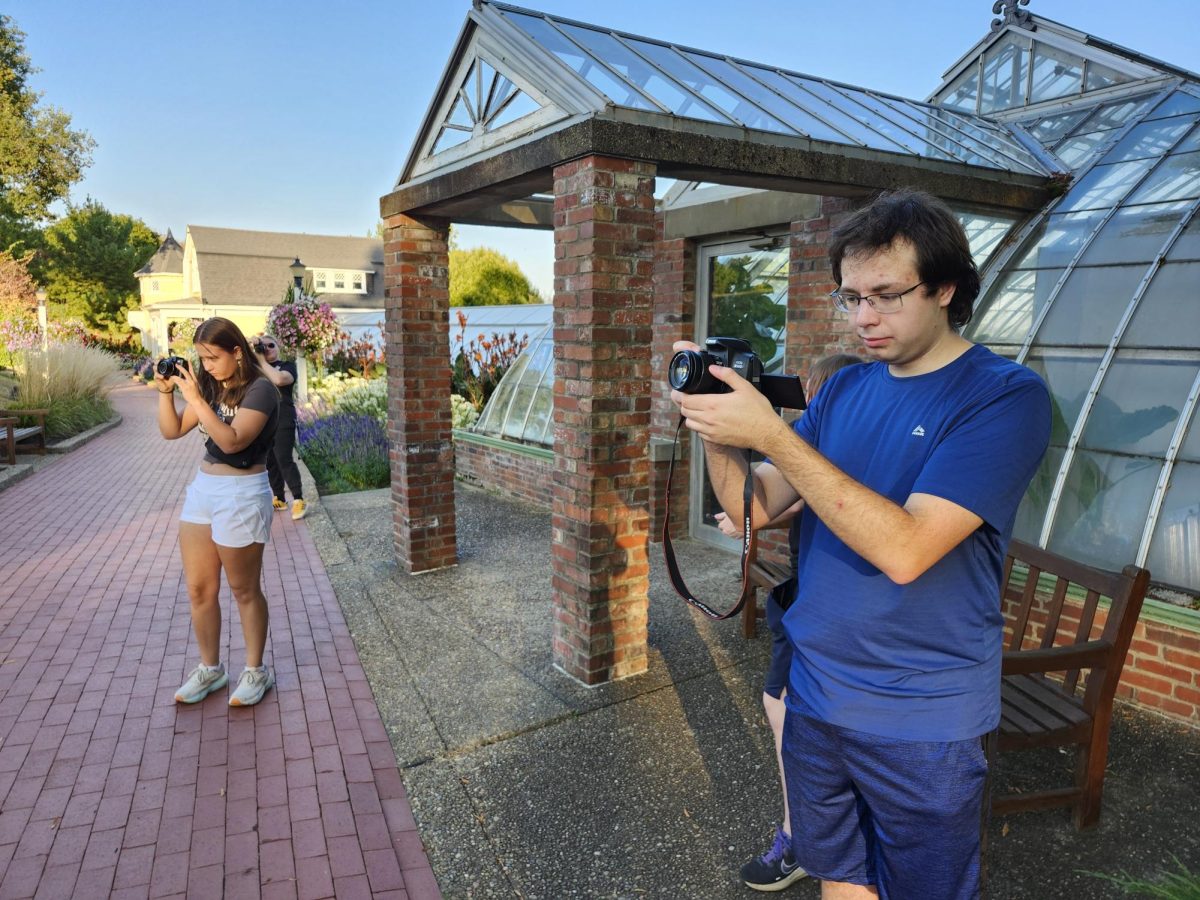 Photo Club students taking photos in front of brick building
