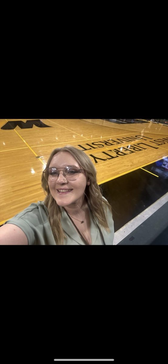 Kaden Bednarek poses in front of the sidelines at the WLU Basketball Court.