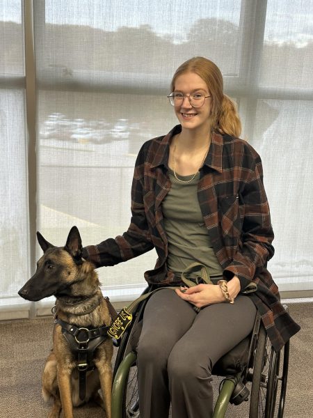 WLU student Elizabeth Simon poses with her service dog.