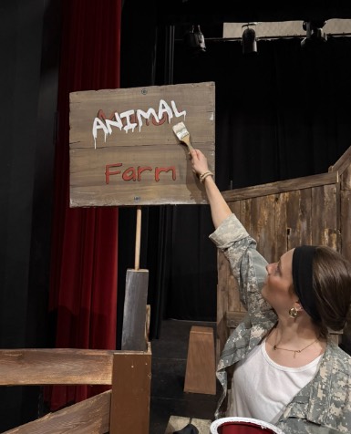 Willow Peyton paints the "new name" of the farm.