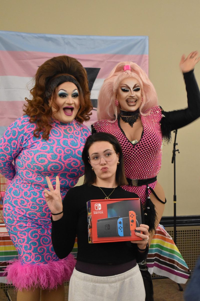 Dixie Sherwood and Alora Chateaux pose with winner of the grand prize Nintendo Switch