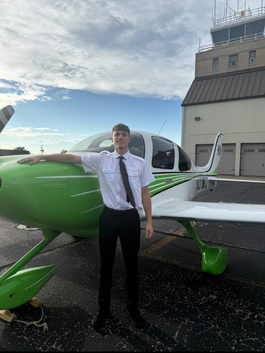 Aviation student Brady Bauer poses with a plane (photo provided)