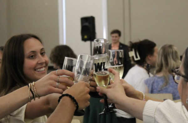 Students clink glasses at the Spring 2026 Grad Toast.